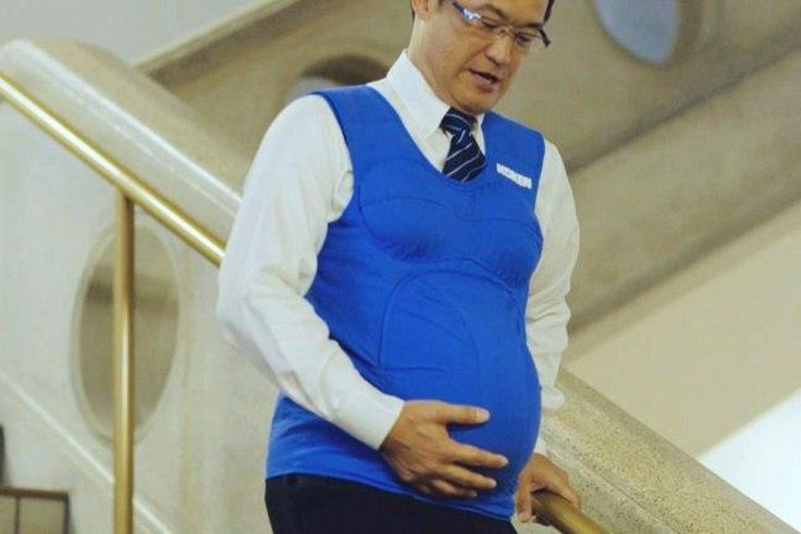 Japanese politician Shunji Kono wears a pregnancy vest in a video filmed by the Kyushu-Yamaguchi Work Life Balance Promotion Campaign