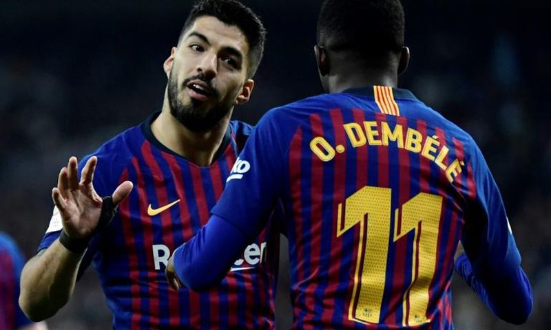 Man of the moment: Barcelona forward Luis Suarez celebrates with Ousmane Dembele