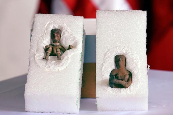 Anthropomorphic clay figures belonging to the Teotihuacan culture are displayed at the US Embassy in Mexico City during a ceremony where the US Federal Bureau of Investigation handed them back after a raid on the home of a US collector