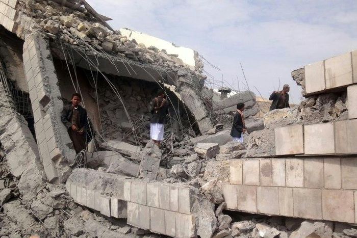 A Yemeni boy stands on the rubble of a school destroyed by a Saudi-led air strike on the outskirt of the northwestern Saada province