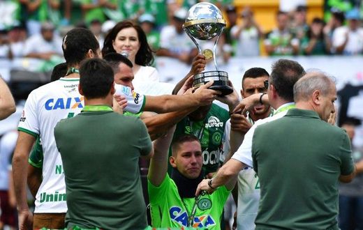 Brazilian Chapecoense goalkeeper Jackson Follmann (C), holds up the Copa Sudamericana trophy before a friendly match against Palmeiras