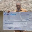 Julius Kerich poses with his Sh31million Sportpesa dummy cheque.