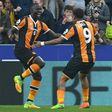 Hull City's Oumar Niasse (L) celebrates with teammate Abel Hernandez after scoring the opening goal of their English Premier League football match against Swansea City on March 11, 2017