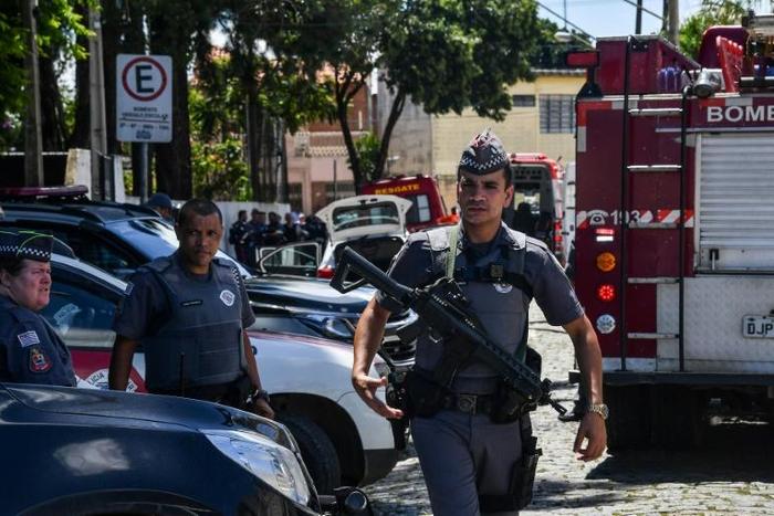 Police work at the scene of a shooting at a school near Sao Paulo on March 13, 2019, that left eight people dead