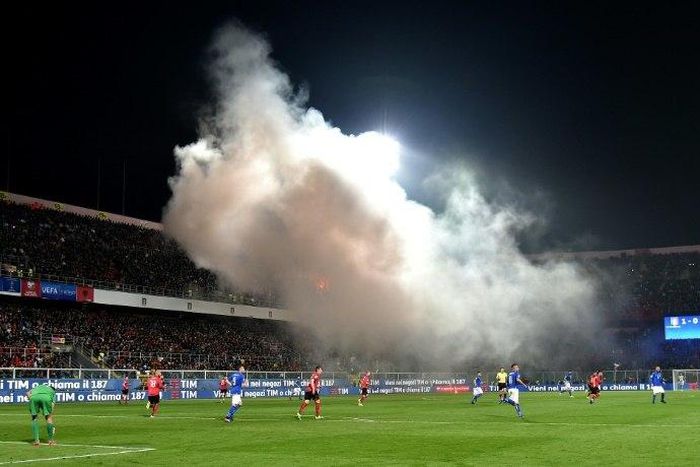 Albania's supporters throw smoke bombs and flares during the FIFA World Cup 2018 qualification football match against Italy March 24, 2017