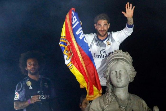 Real Madrid's captain Sergio Ramos (R) and defender Marcelo celebrate the team's La Liga title, at the Plaza de Cibeles in Madrid, on May 21, 2017