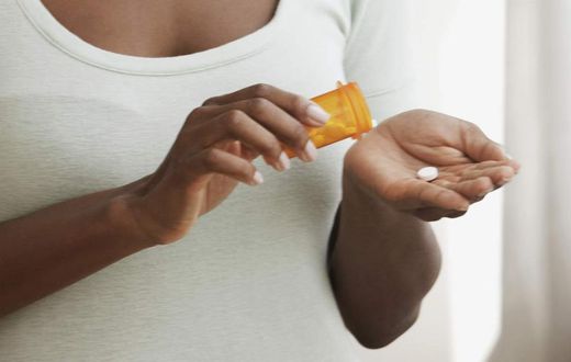 Woman taking meds (Courtesy)