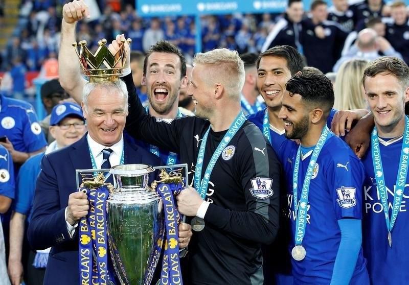 Britain Soccer Football - Leicester City v Everton - Barclays Premier League - King Power Stadium - 7/5/16. Leicester City manager Claudio Ranieri, Kasper Schmeichel (2nd L) and Riyad Mahrez (2nd R) with the trophy as they celebrate winning the Barclays Premier League.