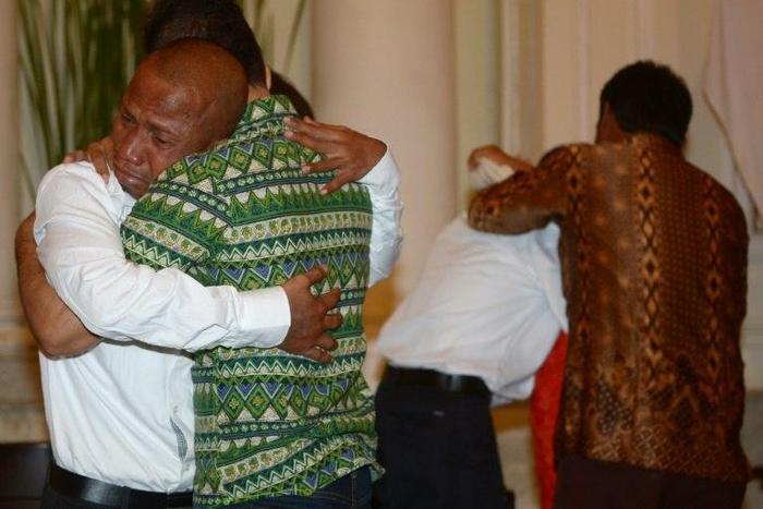 Elson Pesireron (L) hugs his brother Sammy as he and other freed Indonesian sailors held hostage for nearly five years by Somali pirates reunite with family members at the Foreign Ministry office in Jakarta on October 31, 2016