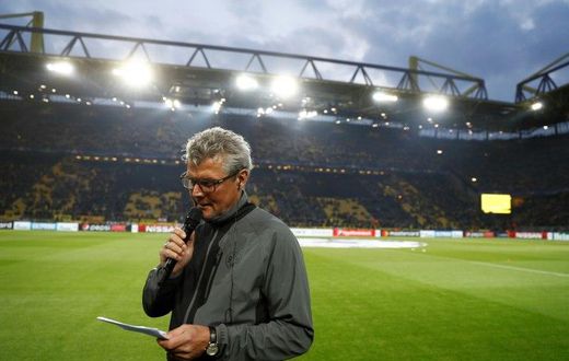 Dortmund's Norbert Dickel announces the postponement of the match after the team bus of Borussia Dortmund had some windows broken by an explosion prior to the UEFA Champions League match BVB Borussia Dortmund v Monaco on April 11, 2017