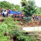 People look at the wreckage of a bus that plunged into a gorge while transporting children from Arusha to Karatu, on May 6, 2017