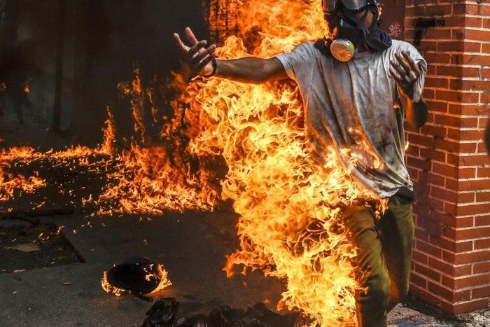 A demonstrator catches fire during clashes in a Caracas protest
