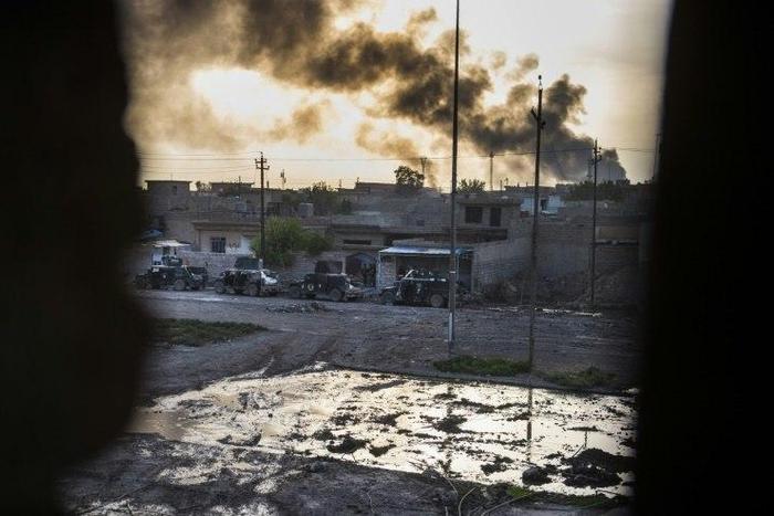 Smoke billows from Islamic State positions as a convoy from the Iraqi Special Forces 2nd division move into position during fighting in the eastern Samah area of Mosul