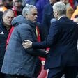 Arsenal manager Arsene Wenger shakes hands with Manchester United manager Jose Mourinho (2nd L) after Aresnal win the game 2-0