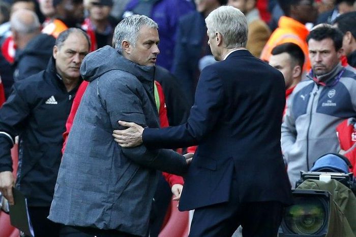 Arsenal manager Arsene Wenger shakes hands with Manchester United manager Jose Mourinho (2nd L) after Aresnal win the game 2-0