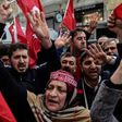 Protesters shout slogans and wave Turkish national flags in front of the Dutch Consulate in Istanbul on March 12, 2017