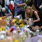 People lay flowers in tribute to the victims of the May 22 bomb attack in Manchester in northern England
