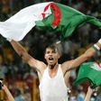 Algeria's goalkeeper Faouzi Chaouchi celebrates after winning the 2010 World Cup qualifying play-off football match against Egypt on November 18, 2009