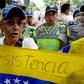 An opposition supporter holds a Venezuela's national flag as she marches protesting against the government of President Nicolas Maduro, in Caracas, on November 10, 2016