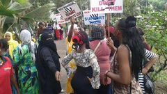 Kenyans prostitutes hold placards in protest over the murder of their colleague.