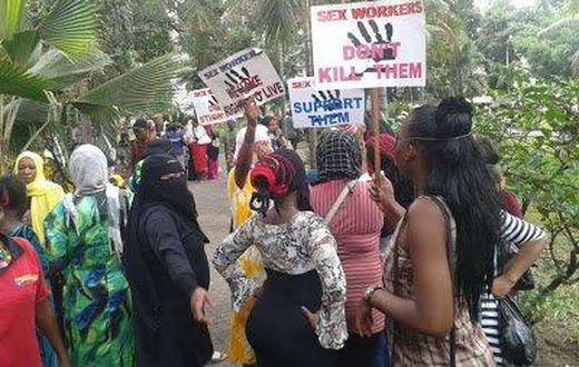 Kenyans prostitutes hold placards in protest over the murder of their colleague.