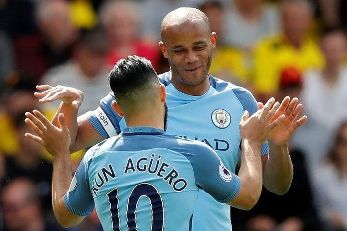 Manchester City's defender Vincent Kompany (R) celebrates scoring against Watford with striker Sergio Aguero on May 21, 2017