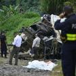 Policemen and rescue officials check the site where a bus plunged off a steep road killing 11 and injuring 12 in Heredia, Vara Blanca, Costa Rica on October 20, 2016