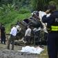 Policemen and rescue officials check the site where a bus plunged off a steep road killing 11 and injuring 12 in Heredia, Vara Blanca, Costa Rica on October 20, 2016