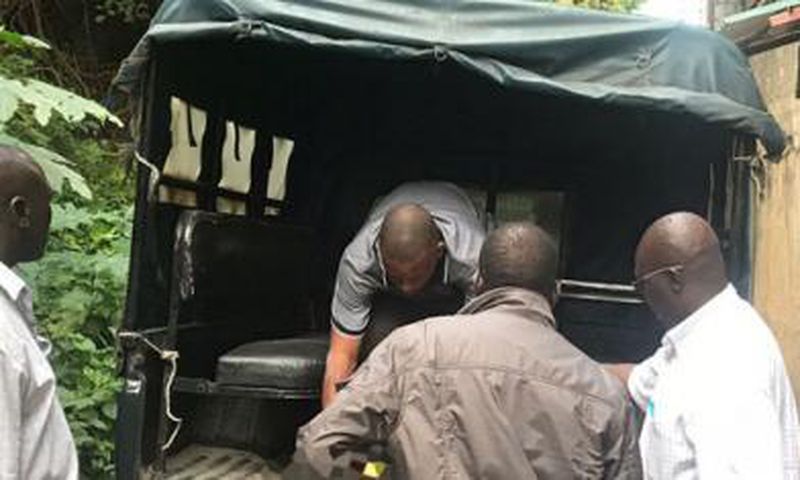 File image of police carrying a body into a police van. David Yano killed by family after spraying six children with bullets in Elgeyo Marakwet
