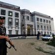 Pakistani policemen stand guard outside the hostel at Abdul Wali Khan university where students beat to death a classmate in Mardan on April 13, 2017
