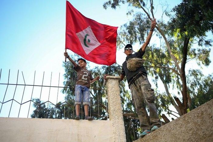 A Moroccan boy holds a flag during a demonstration against corruption, repression and unemployment in the northern city of Al-Hoceima on May 18, 2017