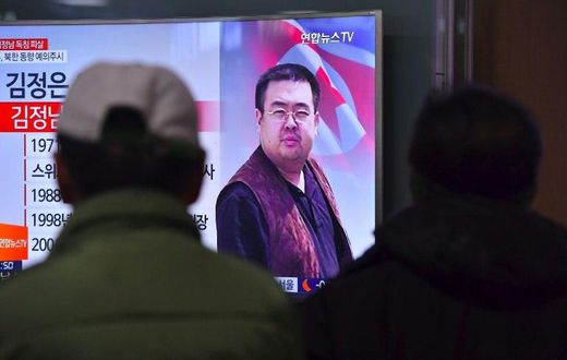 People in a Seoul railway station watch a television news report on the death of Kim Jong-Nam, the half-brother of North Korean leader Kim Jong-Un