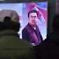 People in a Seoul railway station watch a TV news report on the death of Kim Jong-Nam