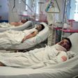 Afghan men receive medical treatment at a Kabul hospital, among hundreds wounded in the massive blast