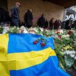 People gather at a makeshift memorial to commemorate the victims of Friday's terror attack near the site where a truck drove into Ahlens department store in Stockholm, Sweden, on April 10, 2017