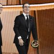 Writer/producer Tim Carvell (L) and TV personality John Oliver accept Outstanding Variety Talk Series for 'Last Week Tonight with John Oliver' at the 2016 Emmy Awards