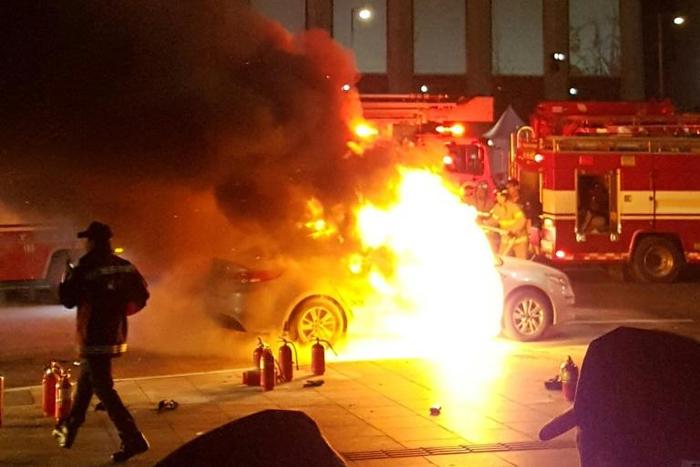 Photo by eyewitness Lee Sang-ho shows a burning taxi as a driver commits suicide near the US embassy in Seoul