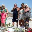 A British family, who witnessed the beach massacre by a jihadist gunman in Tunisia, lay flowers at the site of the attack on the outskirts of Sousse on June 30, 2015
