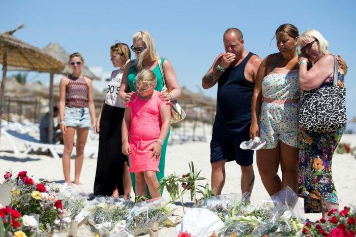 A British family, who witnessed the beach massacre by a jihadist gunman in Tunisia, lay flowers at the site of the attack on the outskirts of Sousse on June 30, 2015