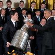 US President Barack Obama (R) gestures as Pittsburgh Penguins captain Sidney Crosby (L) picks up the Stanley Cup during an event at the White House in Washington, DC, October 6, 2016, honoring the Penguins 2016 Stanley Cup victory