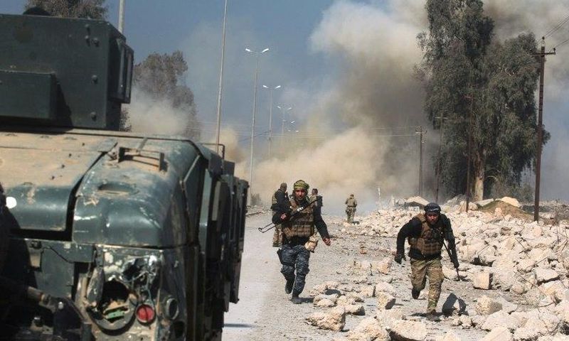 Smoke billows in the background as Iraqi forces advance on Mosul airport during an offensive to retake the western side of the city from jihadists of the Islamic State group on February 23, 2017