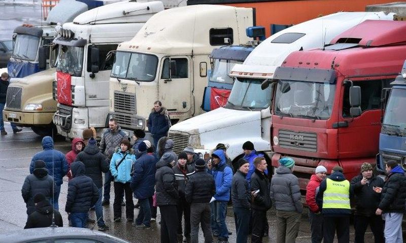 Russian long-distance truck drivers gather at a parking in Khimki, outside Moscow, on December 4, 2015, to protest against the Platon truck taxation system, a system against which truckers have launched a new protest