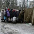 Residents of the war-scarred and cashed-starved Ukraine queue outside a tent to get warm clothes in Avdiivka, Donetsk region, on February 5, 2017