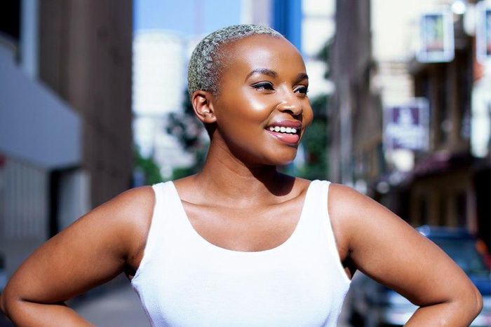 Joy Kendi in a ruched white pencil skirt and tank top