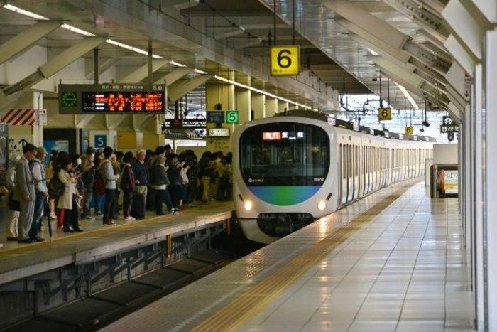 Japanese police are investigating dozens of cases where women had their hair or skirts cut while travelling on a packed commuter train