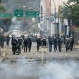Riot police and opposition activists clash in Caracas on April 10, 2017 after Venezuela's political crisis intensified following the Supreme Court's ruling that curbed the powers of the opposition-controlled legislature