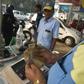 An Indian customer pays for fuel with old 500 rupee notes at a petrol station in New Delhi on the last day on which the old currency can be used to purchase fuel