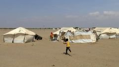 In this file photo, a Yemeni child runs toward a tent at a camp for displaced people in the Khokha district of Hodeida province on December 11, 2018