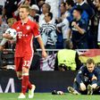 Bayern Munich goalkeeper Manuel Neuer (R) removes his boot during the Champions League quarter-final second leg against Real Madrid at the Santiago Bernabeu stadium in Madrid on April 18, 2017