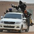 A vehicle carrying migrants travels through Agadez, Niger, en route to Libya in June 2015